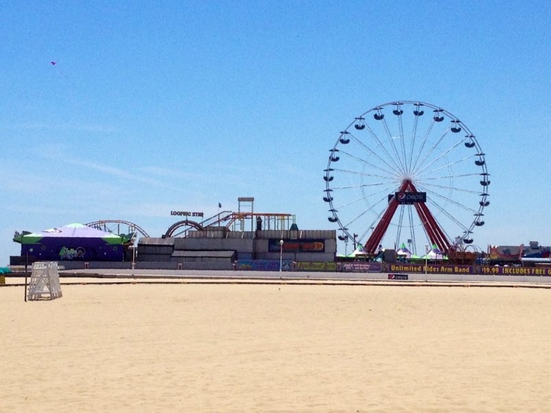 a large ferris wheel sitting on top of a sandy beach