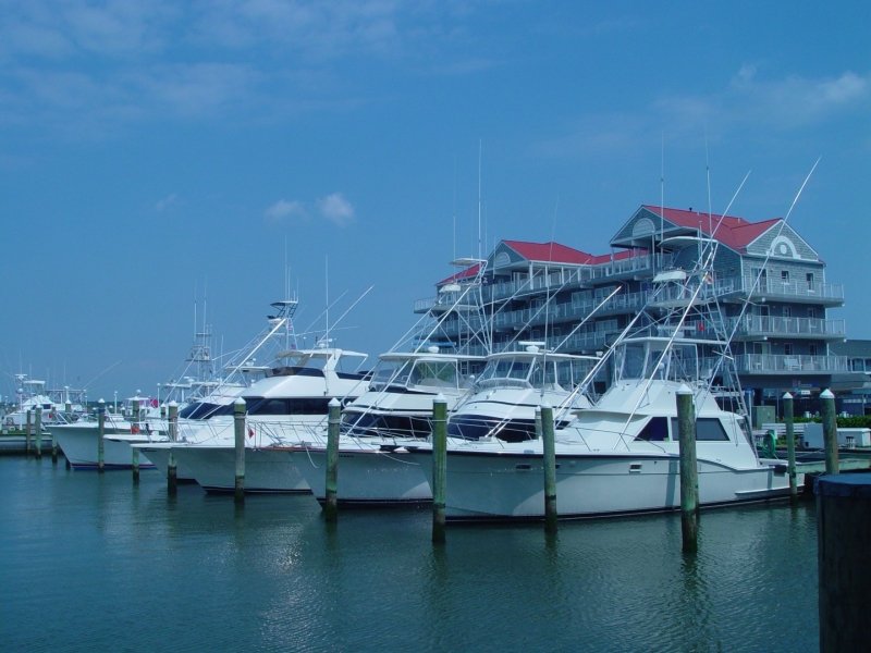 several boats are docked in the water near a building
